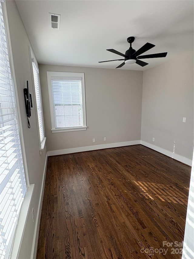 empty room featuring ceiling fan and dark hardwood / wood-style flooring