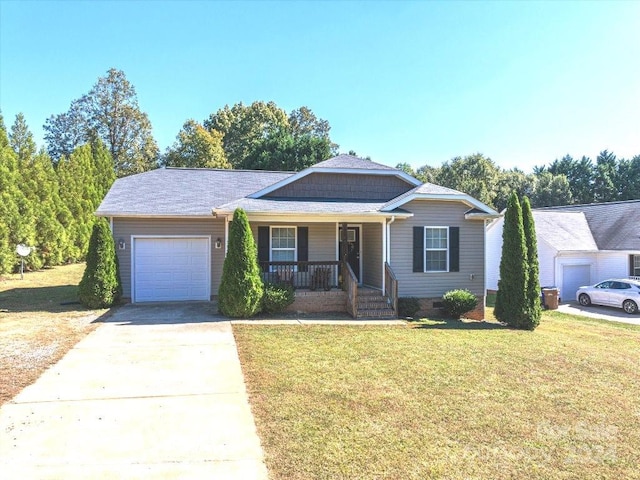 single story home featuring covered porch, a garage, and a front lawn