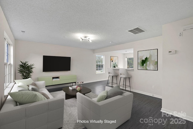 living room featuring dark hardwood / wood-style floors and a textured ceiling