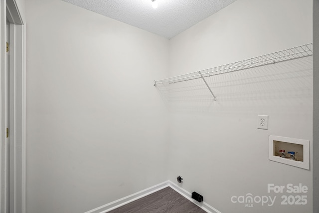 laundry room with washer hookup, a textured ceiling, and hardwood / wood-style floors