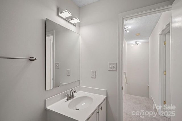 bathroom with a textured ceiling and vanity