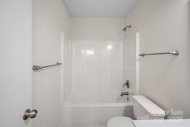 bathroom featuring a textured ceiling and toilet