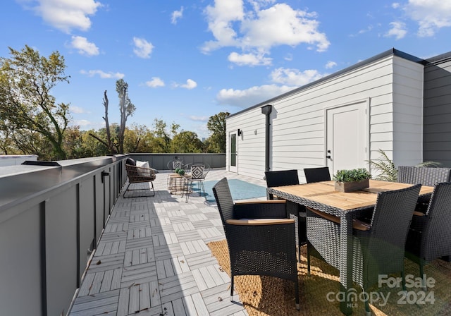 wooden terrace with a patio