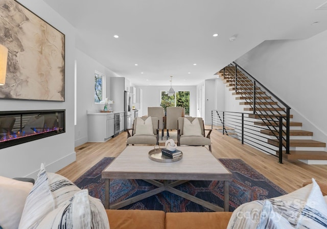 living room with wine cooler and light wood-type flooring