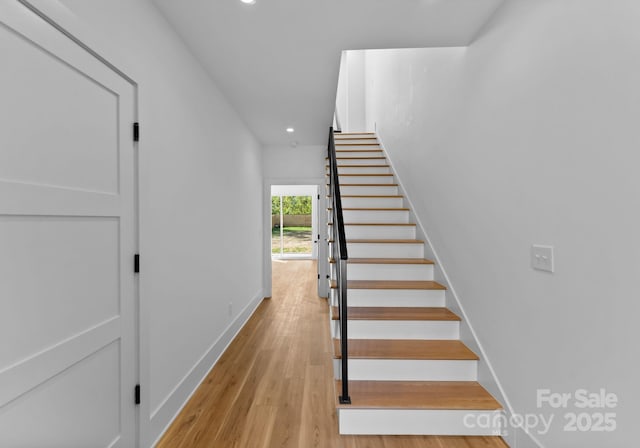 staircase with wood-type flooring