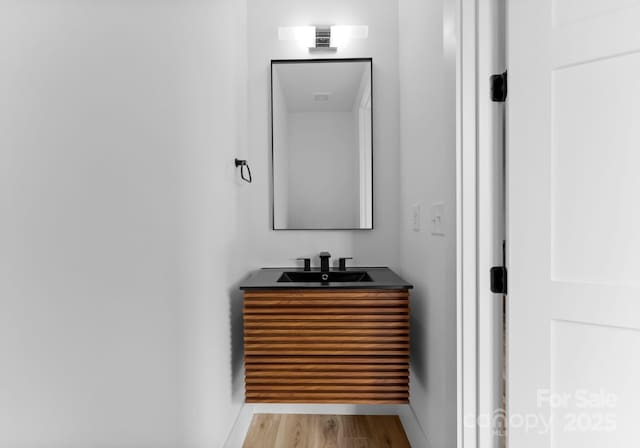 bathroom with vanity and wood-type flooring