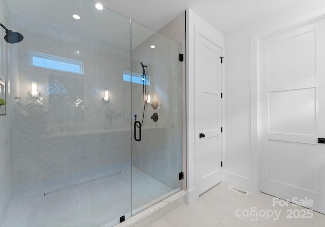 bathroom with a shower with shower door