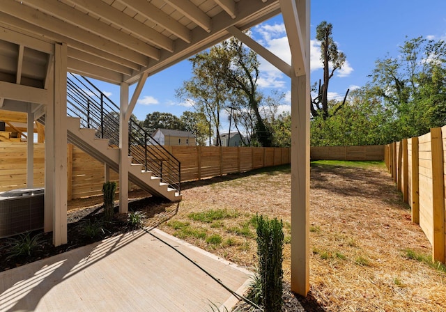 view of yard with cooling unit and a patio