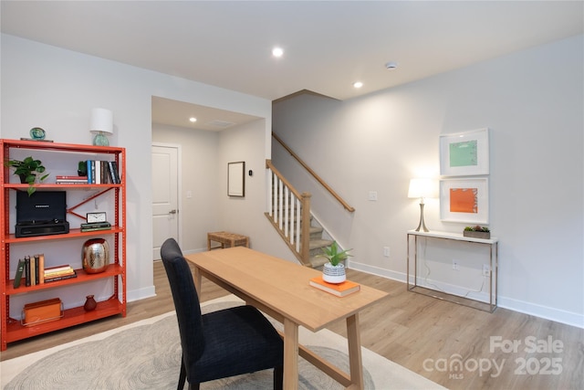 home office with light hardwood / wood-style floors