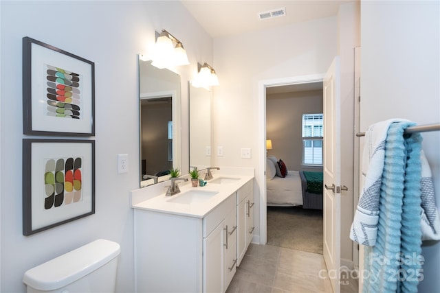 bathroom with tile patterned floors, vanity, and toilet