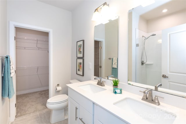 bathroom featuring vanity, a shower, and toilet