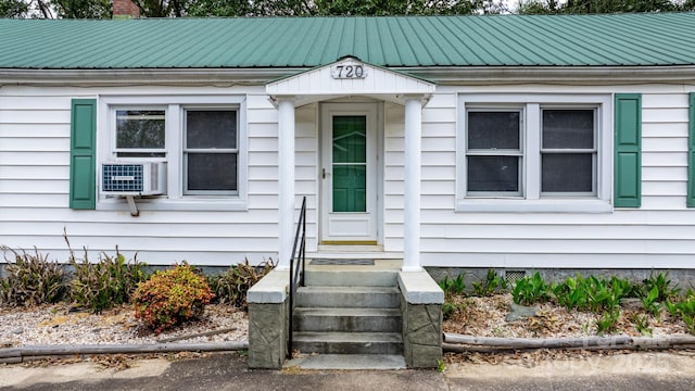 720A-C Harris Ave NW, Valdese, NC 28690 - doorway to property featuring metal roof, cooling unit, and a chimney