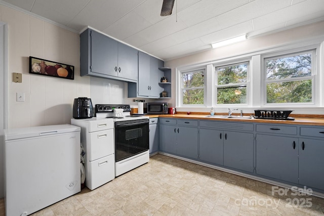 720A-C Harris Ave NW, Valdese, NC 28690 - kitchen featuring refrigerator, open shelves, stainless steel microwave, electric range, and a sink