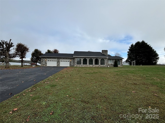 ranch-style home featuring a front yard and a garage