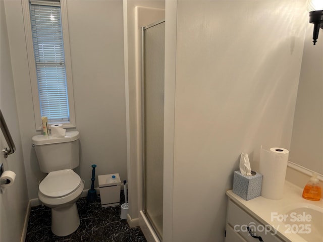 bathroom with vanity, toilet, and an enclosed shower