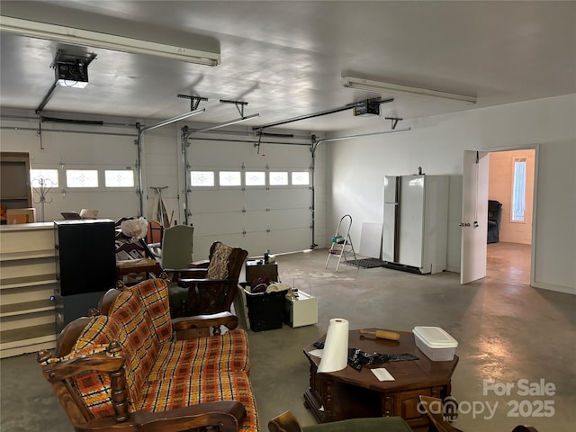 garage featuring refrigerator and a garage door opener