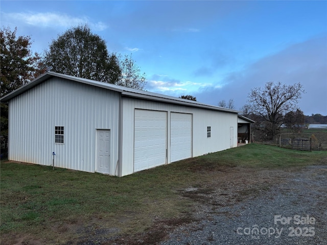 garage featuring a lawn