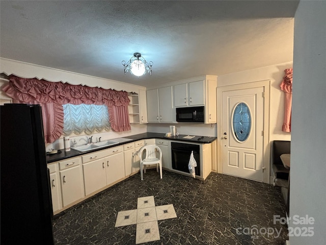 kitchen with sink, white cabinets, black appliances, and a textured ceiling