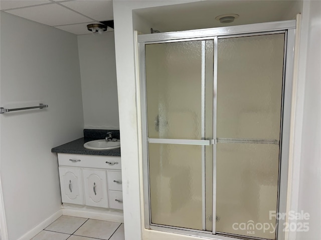 bathroom featuring tile patterned flooring, vanity, and a shower with door