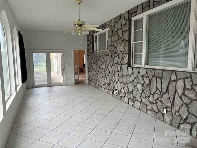 tiled empty room with ceiling fan