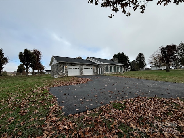 view of front of house featuring a front yard and a garage