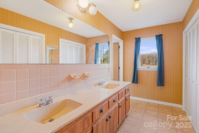 bathroom with vanity, tile patterned floors, and decorative backsplash