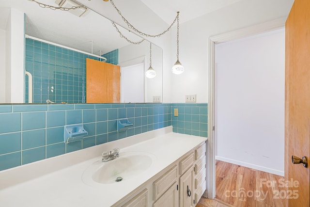 bathroom with vanity, a shower, wood-type flooring, and tile walls