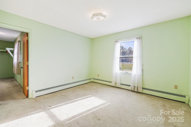 unfurnished room with a baseboard radiator and light carpet