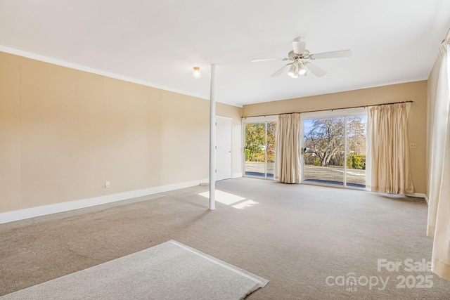 carpeted empty room featuring ornamental molding and ceiling fan