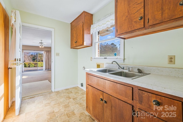 kitchen featuring ceiling fan and sink