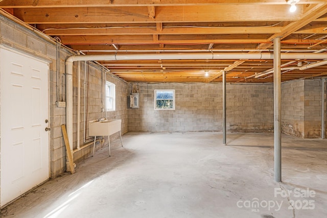 basement with sink and electric panel