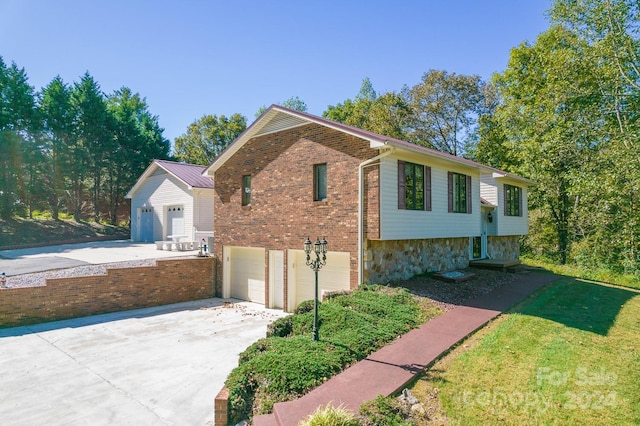 exterior space with a garage and a lawn