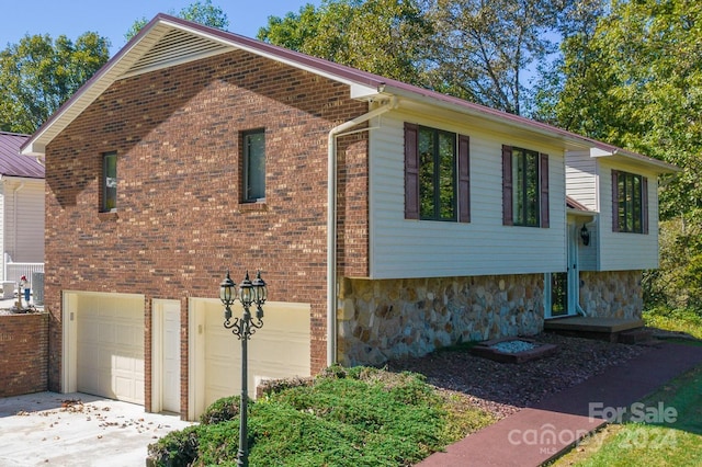 view of side of home featuring a garage