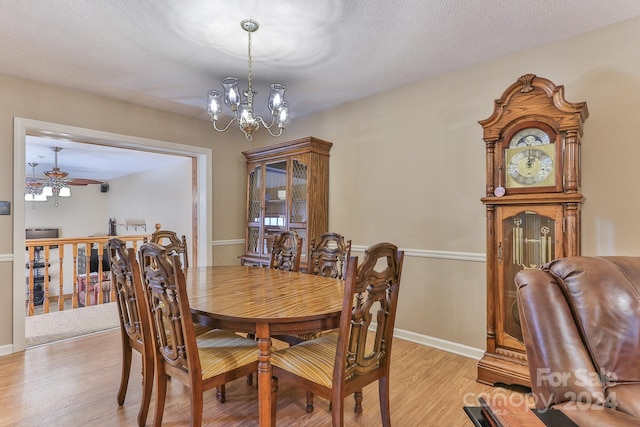 dining room featuring light hardwood / wood-style flooring, a textured ceiling, and ceiling fan with notable chandelier