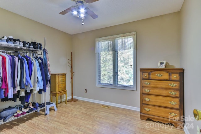 spacious closet featuring light wood-type flooring and ceiling fan