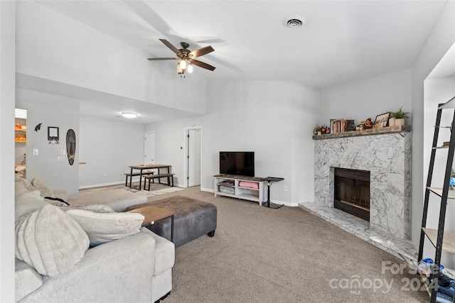 carpeted living room with lofted ceiling, a fireplace, and ceiling fan