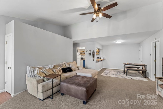 living room with ceiling fan, high vaulted ceiling, and light carpet