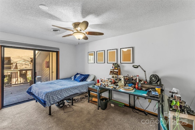 carpeted bedroom featuring access to outside, ceiling fan, and a textured ceiling