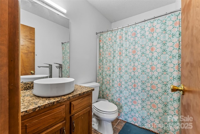 bathroom featuring toilet, vanity, and tile patterned flooring