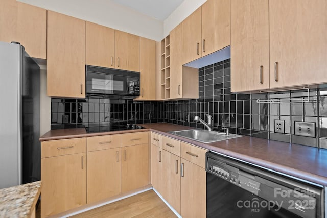 kitchen with tasteful backsplash, sink, light brown cabinets, and black appliances