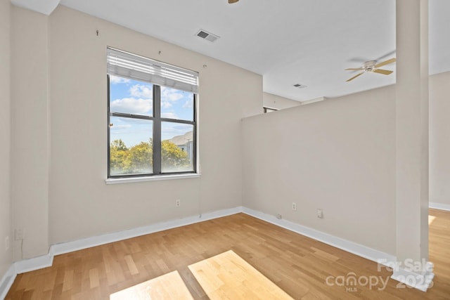 spare room featuring hardwood / wood-style floors and ceiling fan