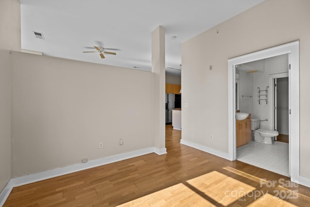 unfurnished room with hardwood / wood-style flooring and ceiling fan