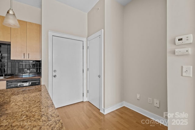 kitchen with dishwasher, tasteful backsplash, light hardwood / wood-style floors, decorative light fixtures, and light brown cabinets