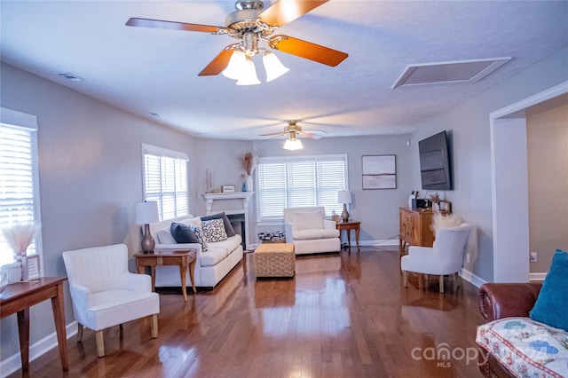 living room featuring wood-type flooring and ceiling fan