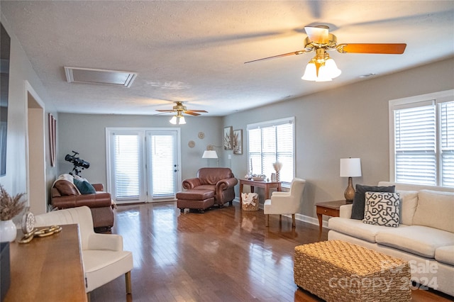 living room with ceiling fan, plenty of natural light, and hardwood / wood-style floors