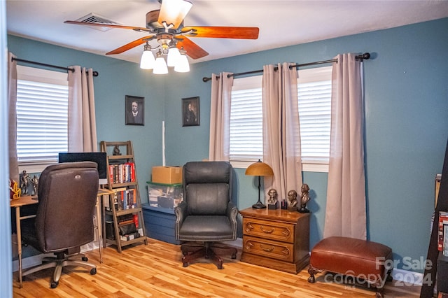 office space with light wood-type flooring and ceiling fan