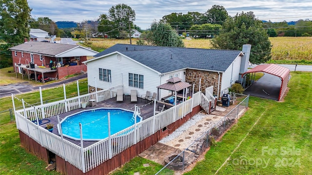 view of swimming pool featuring a deck and a lawn