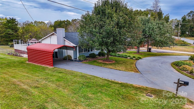 exterior space featuring a front yard and a carport