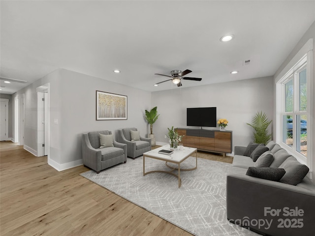 living room featuring light wood-type flooring and ceiling fan