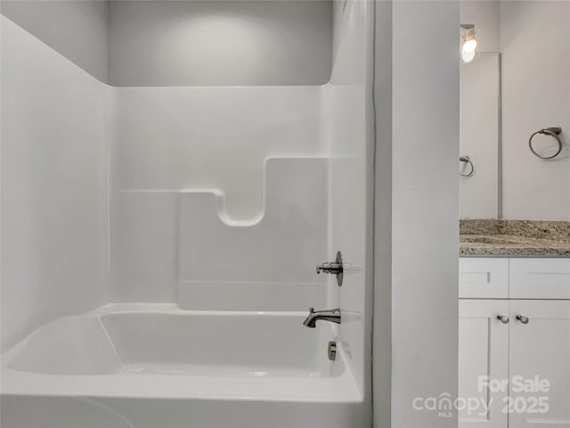 bathroom with vanity and washtub / shower combination